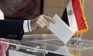An Egyptian expatriate living in Lebanon casts her vote in a referendum on the new Egyptian constitution at the Egyptian embassy in Beirut